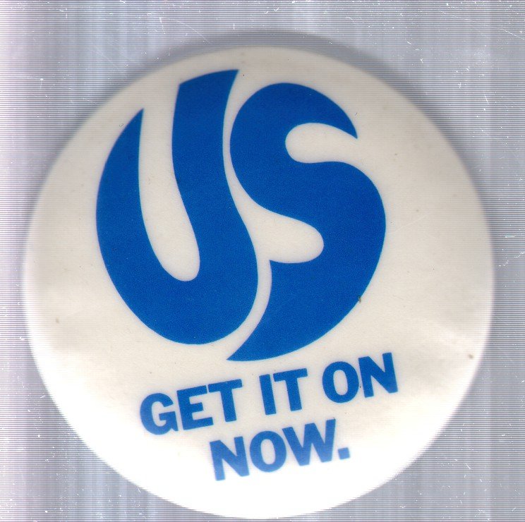 Us Featuring David Essex - Get It On. Now - Badge